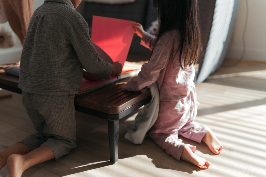 Children in pyjamas doing art together in morning sunlight captured by Lamy N Kim Photography